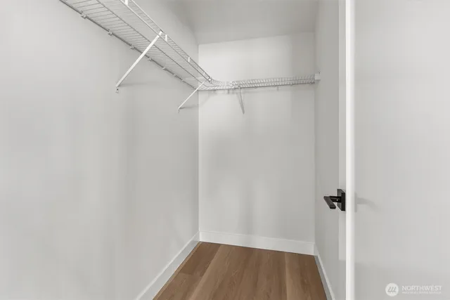 a bedroom with a bed and glass window