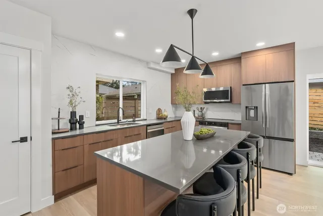 a kitchen with stainless steel appliances a sink and cabinets
