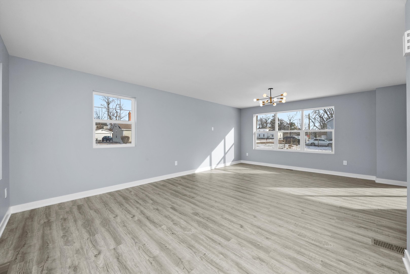 106 West Thompson Street Harvard, IL 60033 - Photo 11 of 46 a view of an empty room with a window and wooden floor