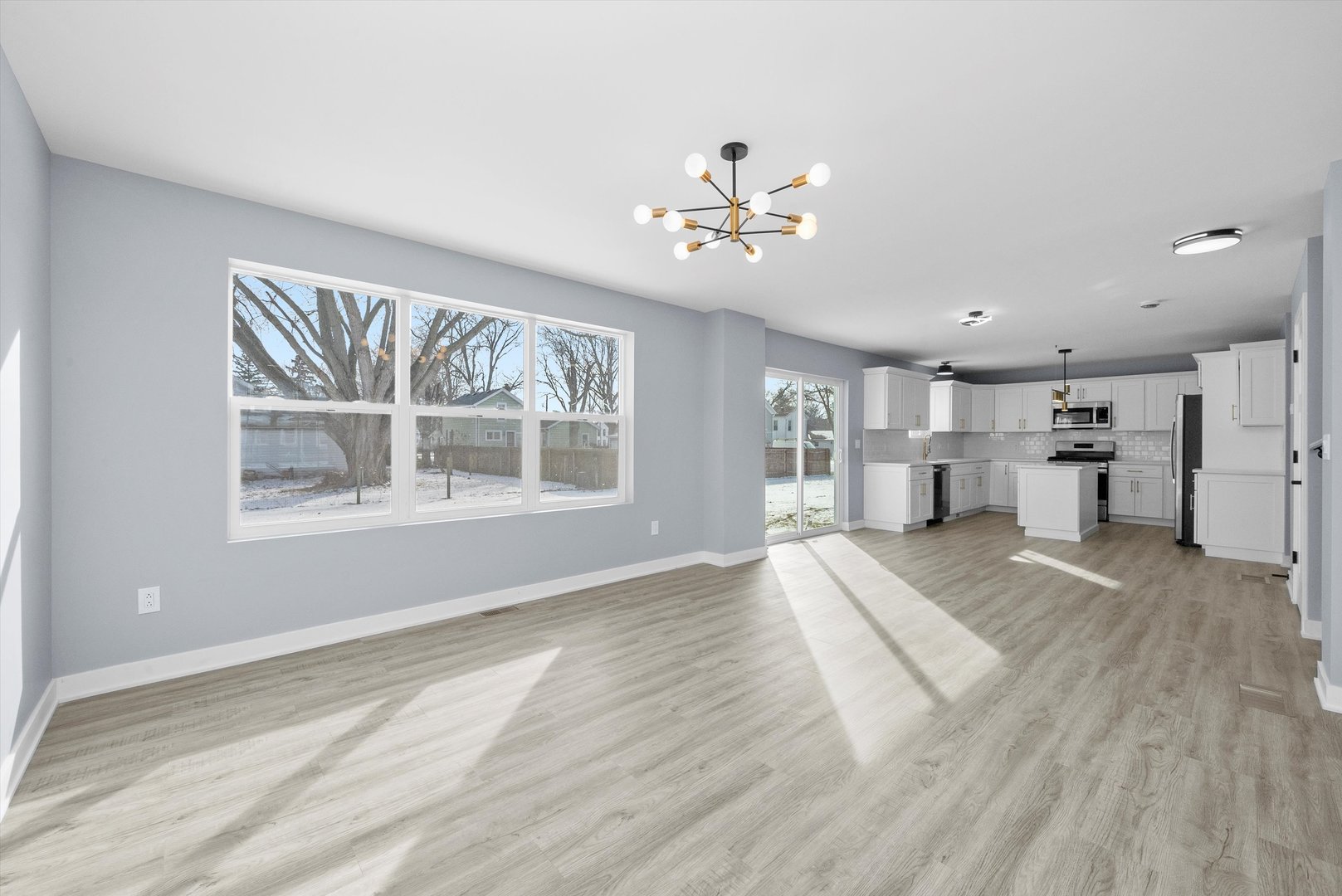 106 West Thompson Street Harvard, IL 60033 - Photo 13 of 46 a view of empty room with wooden floor and window