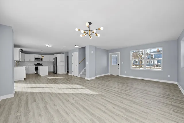 a view of an empty room with a kitchen