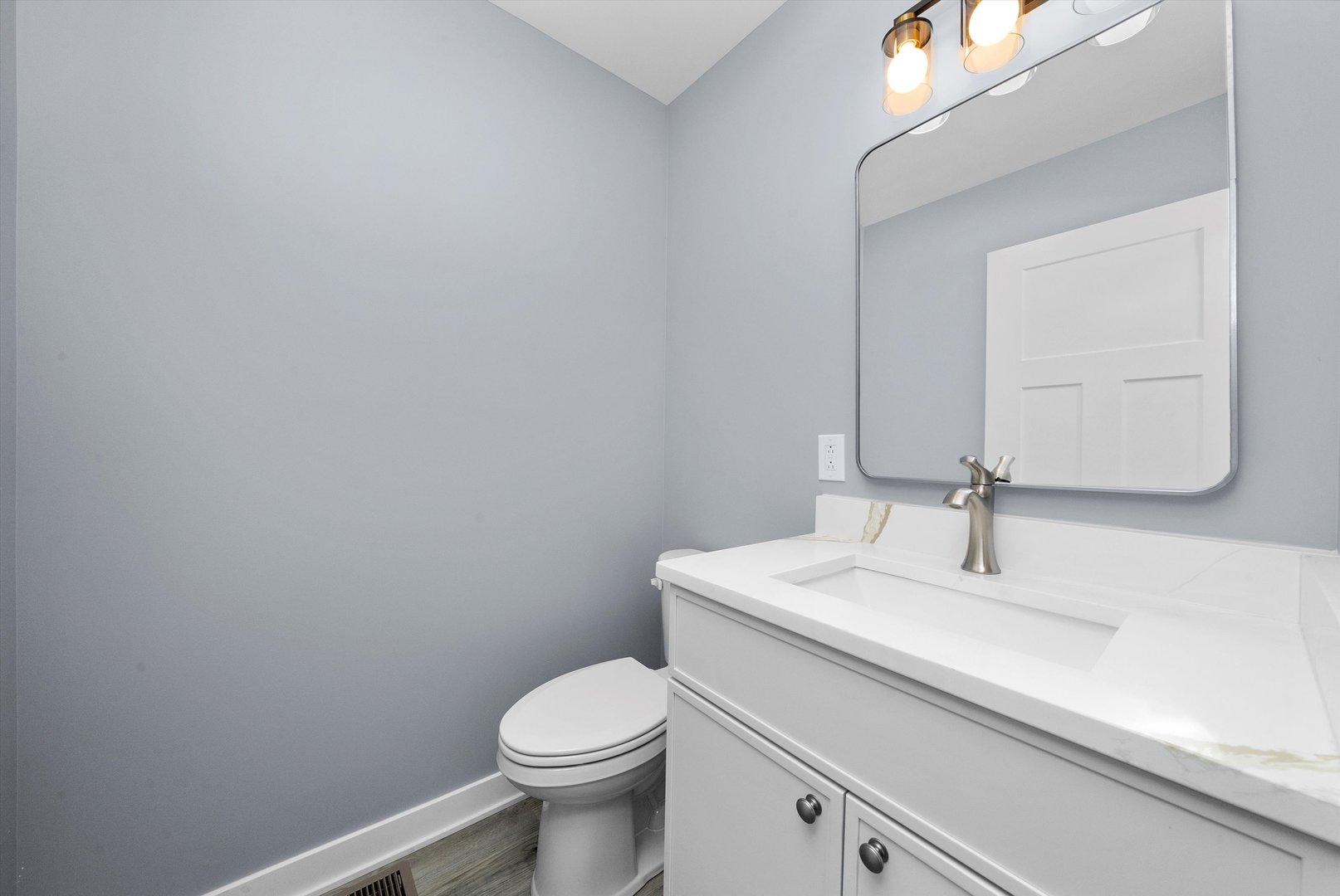 106 West Thompson Street Harvard, IL 60033 - Photo 19 of 46 a bathroom with a sink a toilet and mirror