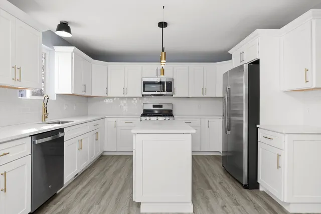 a kitchen with appliances cabinets and a sink