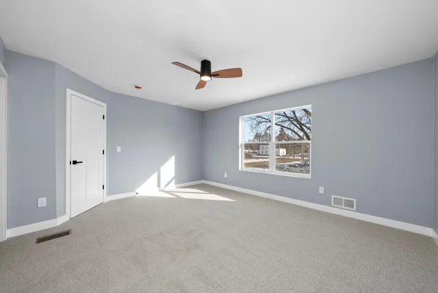 a view of an empty room with a window