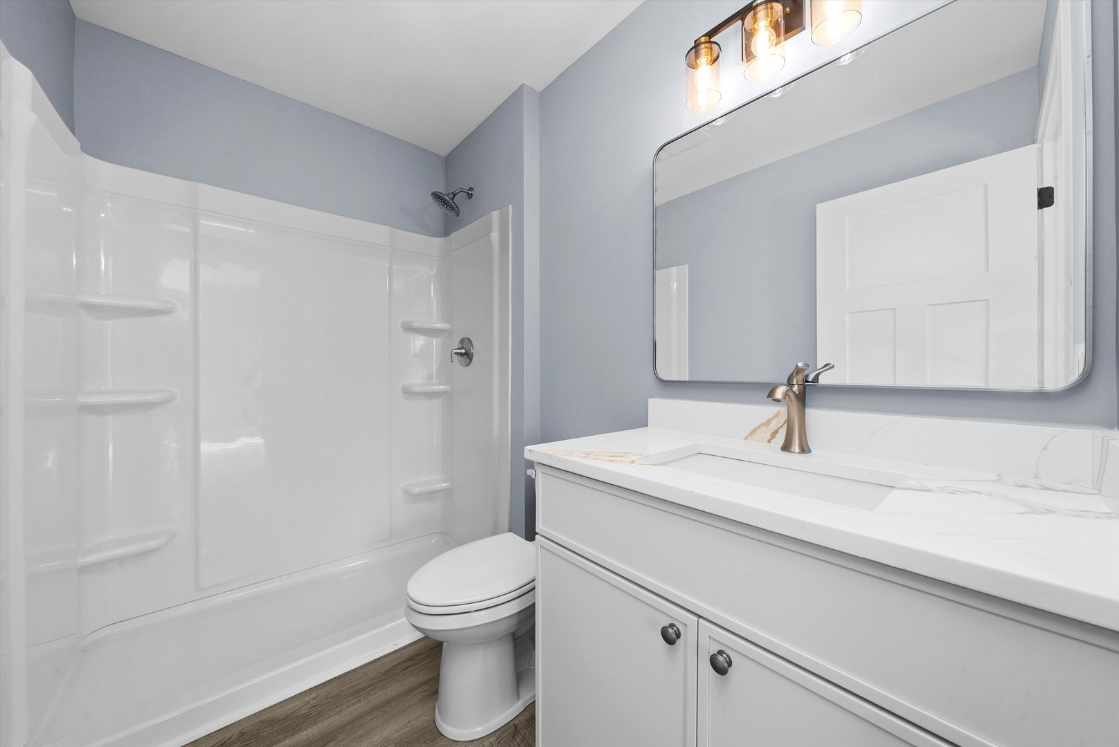 106 West Thompson Street Harvard, IL 60033 - Photo 24 of 46 a bathroom with a sink a toilet and shower