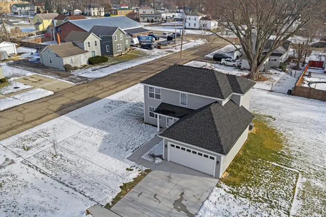 an aerial view of a house with a yard