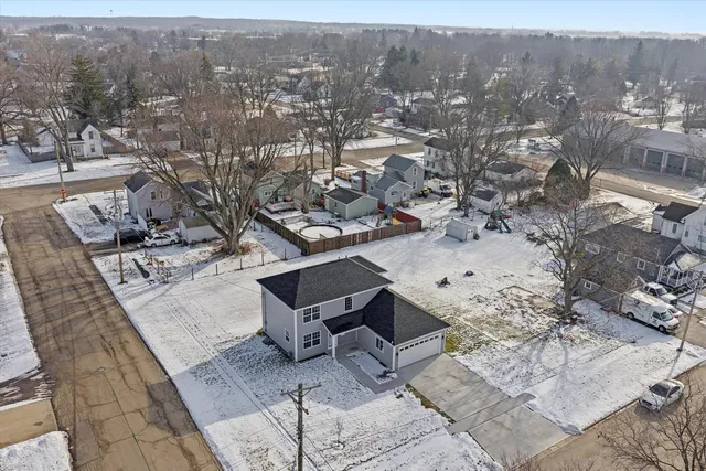 an aerial view of a backyard with table and chairs