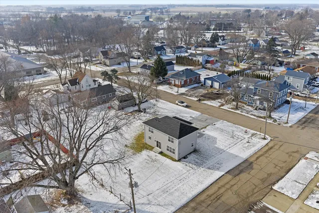 an aerial view of a house with a yard