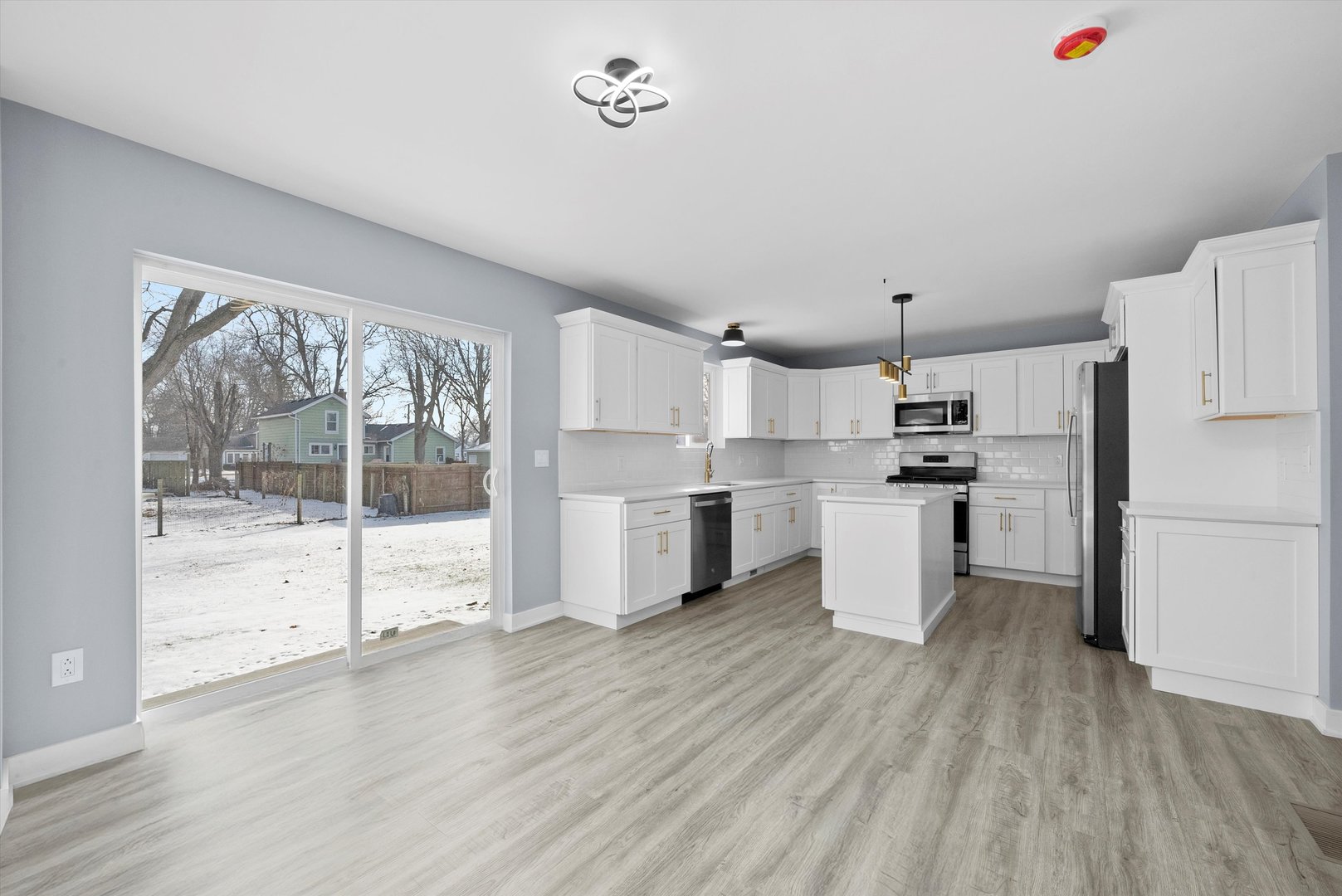 106 West Thompson Street Harvard, IL 60033 - Photo 9 of 46 a kitchen with white cabinets and white appliances