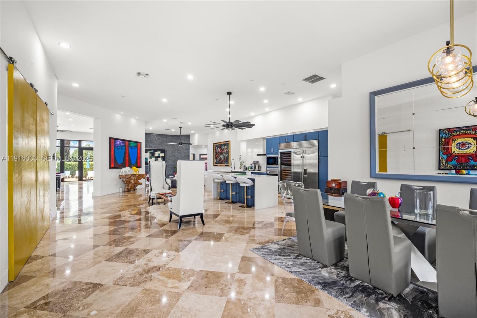 17490 Southwest 70th Place Southwest Ranches, FL 33331 - Photo 14 of 64 a living room with lots of furniture and kitchen view