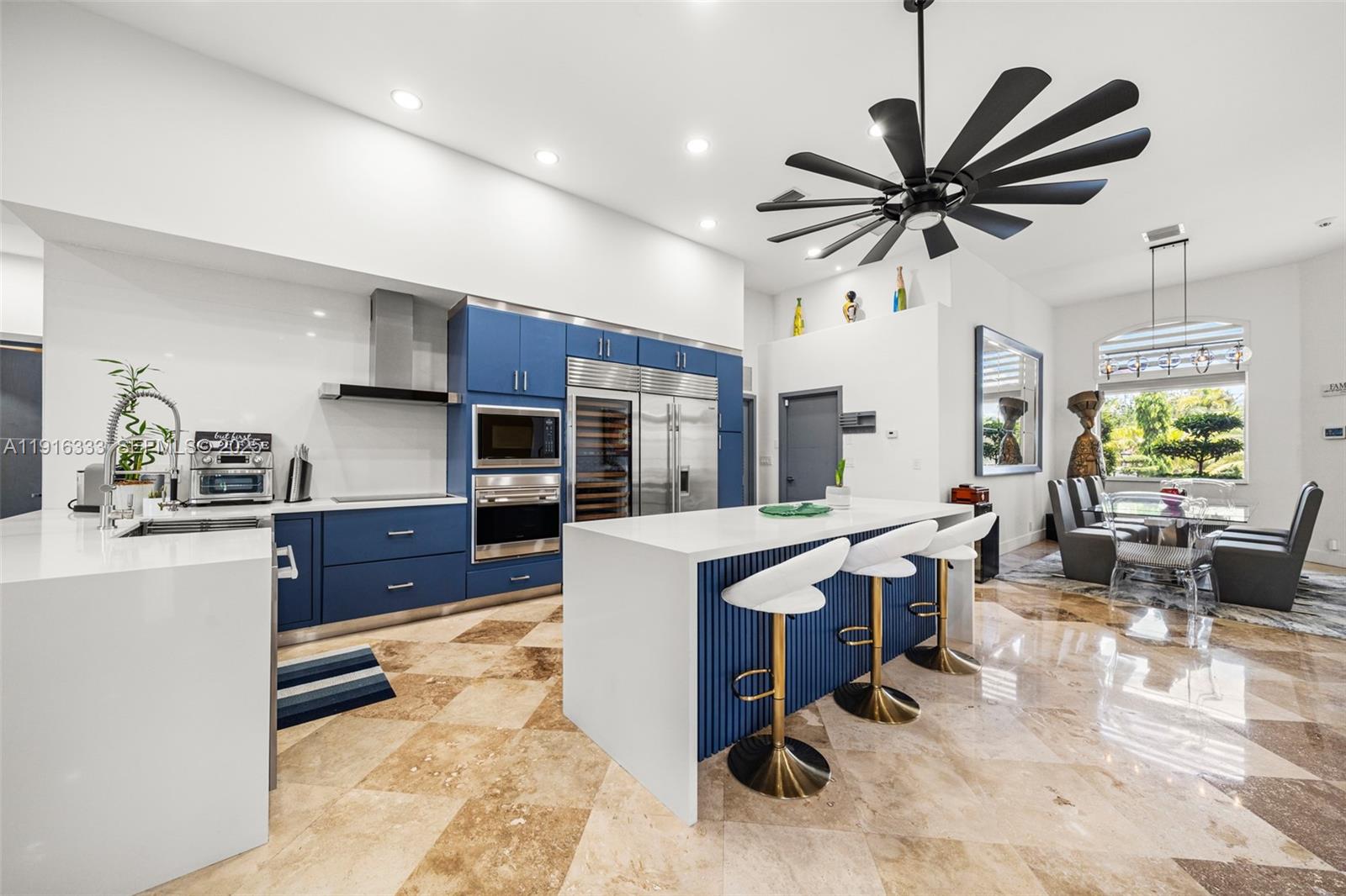 17490 Southwest 70th Place Southwest Ranches, FL 33331 - Photo 18 of 64 a living room with stainless steel appliances kitchen island granite countertop furniture and a wooden floor