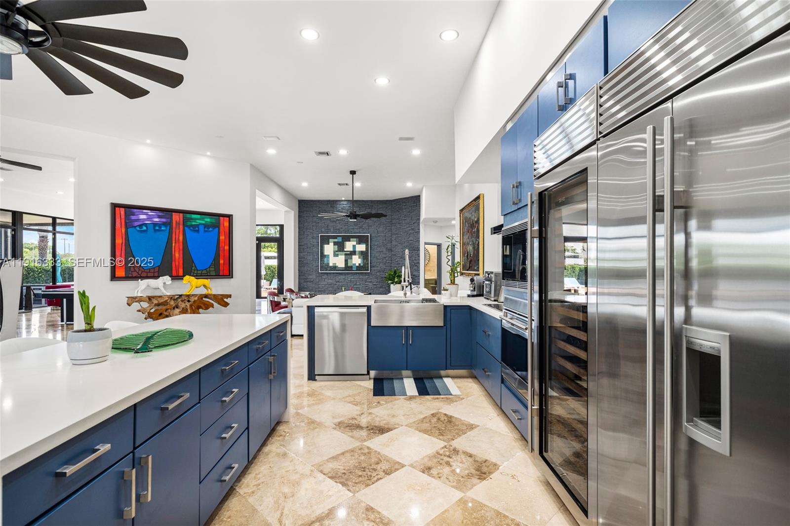 17490 Southwest 70th Place Southwest Ranches, FL 33331 - Photo 20 of 64 a kitchen with stainless steel appliances kitchen island granite countertop a refrigerator and a sink
