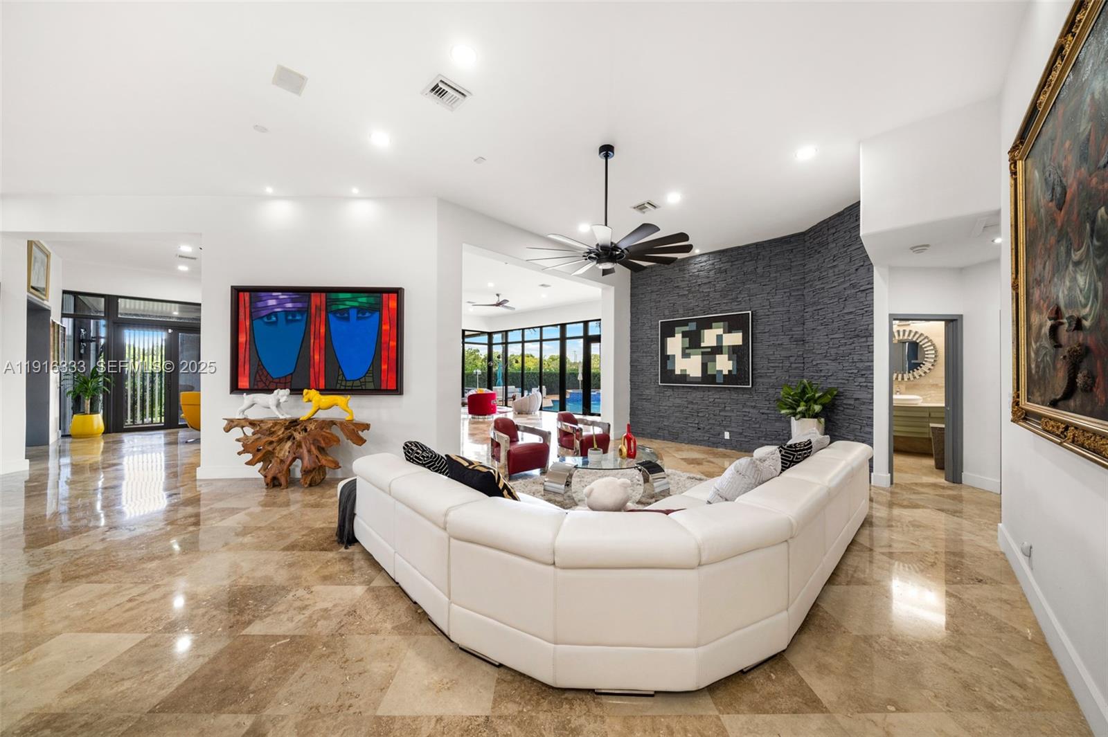 17490 Southwest 70th Place Southwest Ranches, FL 33331 - Photo 22 of 64 a living room with furniture and a flat screen tv