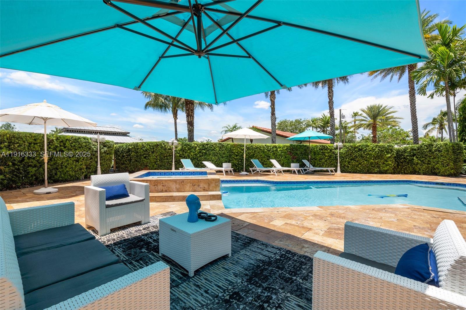17490 Southwest 70th Place Southwest Ranches, FL 33331 - Photo 32 of 64 a view of a patio with couches under an umbrella