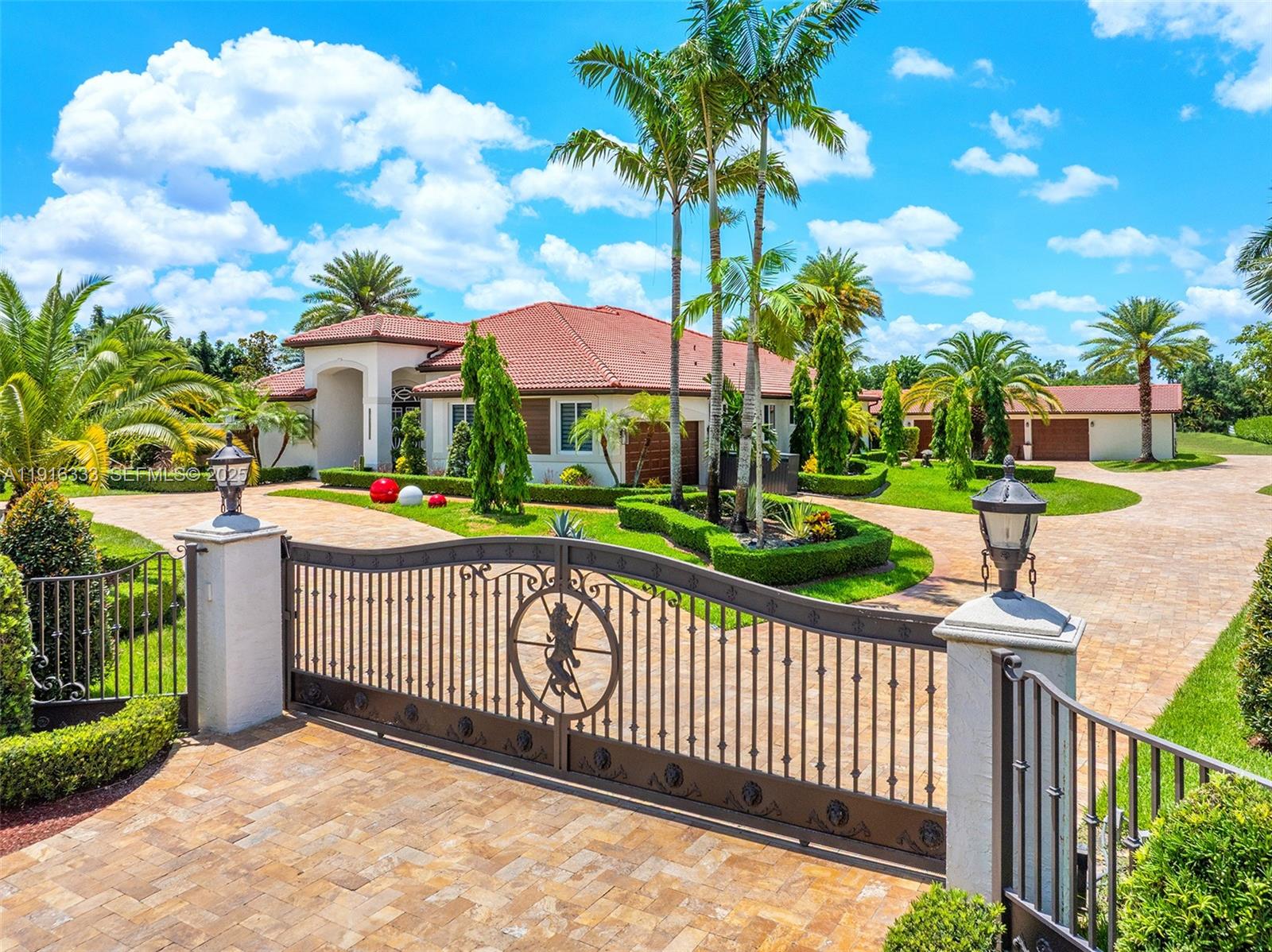 17490 Southwest 70th Place Southwest Ranches, FL 33331 - Photo 4 of 64 a front view of a house with garden and plants