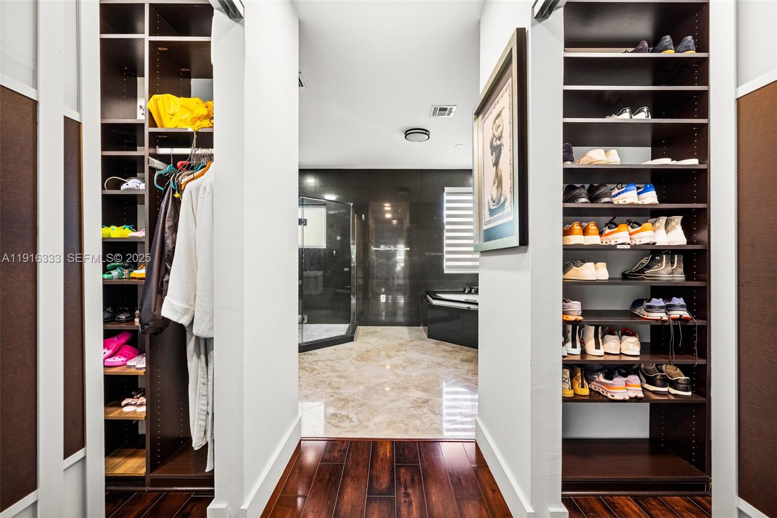 17490 Southwest 70th Place Southwest Ranches, FL 33331 - Photo 41 of 64 a view of walk in closet with clothes and shoes