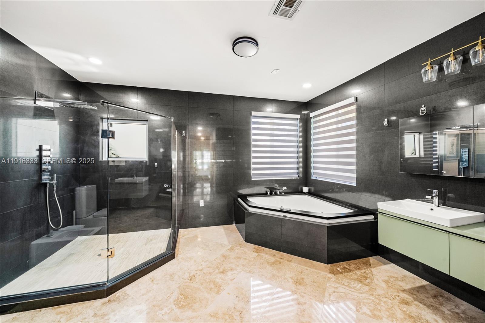 17490 Southwest 70th Place Southwest Ranches, FL 33331 - Photo 43 of 64 a bathroom with a double vanity sink a toilet a mirror and shower