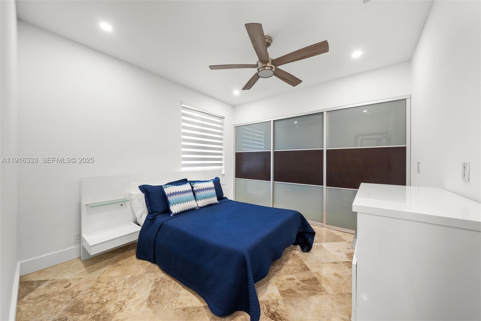 17490 Southwest 70th Place Southwest Ranches, FL 33331 - Photo 45 of 64 a bedroom with a bed a chandelier and a rug