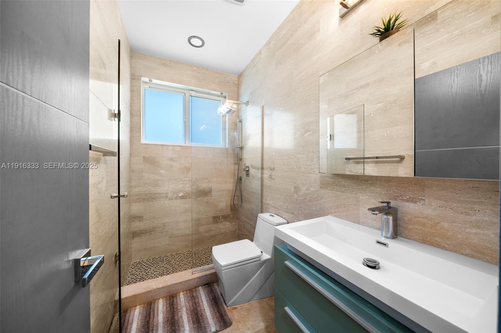 17490 Southwest 70th Place Southwest Ranches, FL 33331 - Photo 46 of 64 a bathroom with a sink a toilet and shower