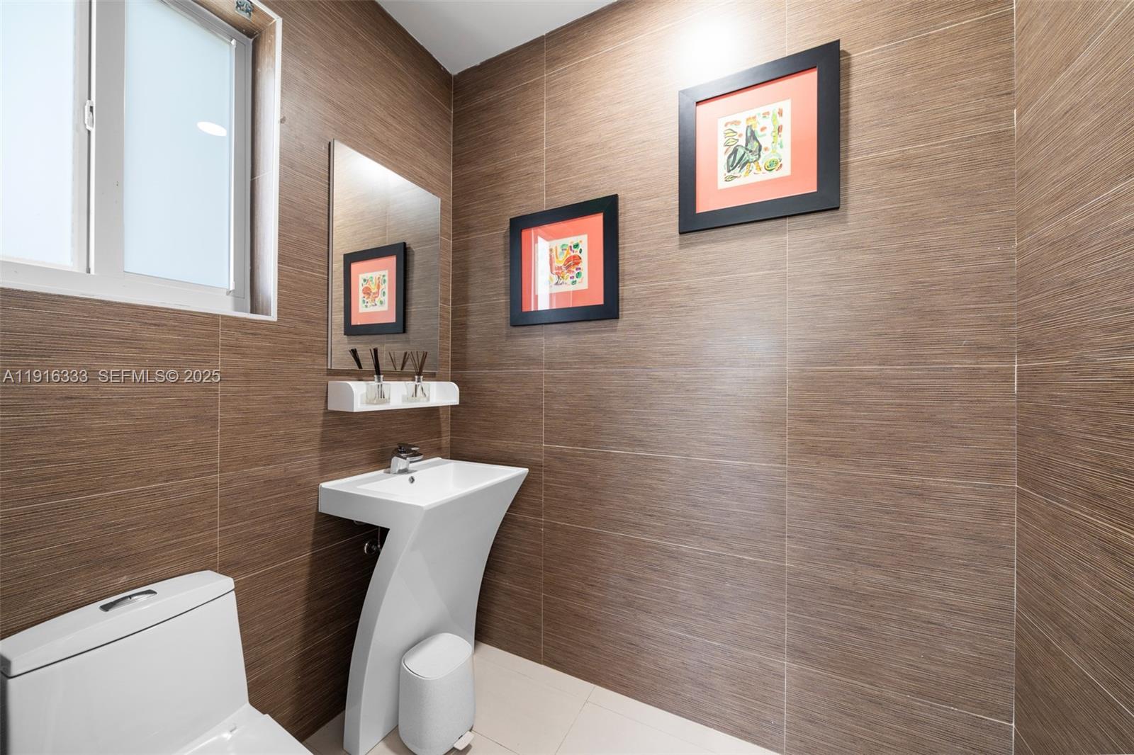 17490 Southwest 70th Place Southwest Ranches, FL 33331 - Photo 49 of 64 a bathroom with a toilet a sink and mirror