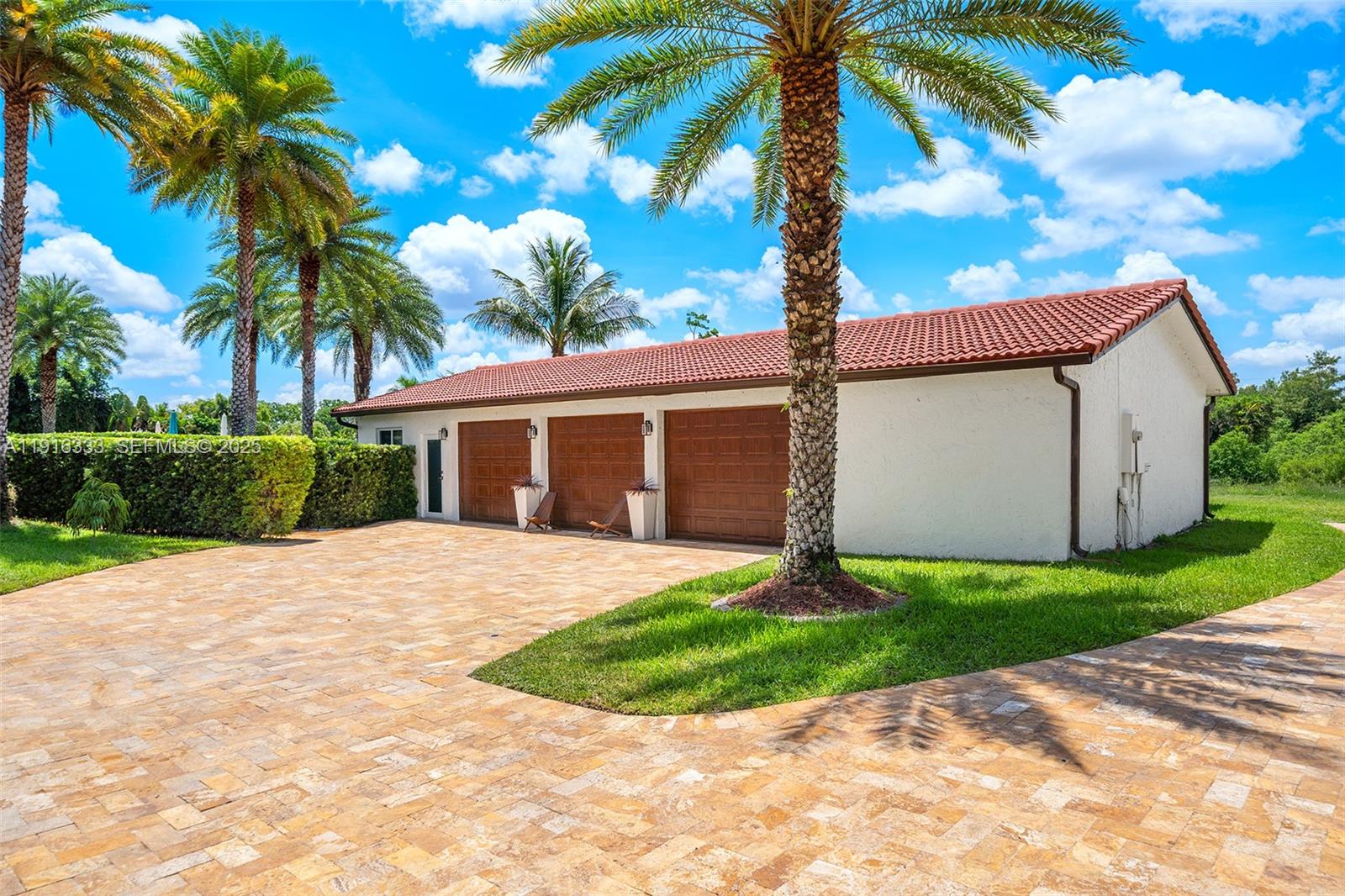 17490 Southwest 70th Place Southwest Ranches, FL 33331 - Photo 51 of 64 a front view of a house with a garden and entryway