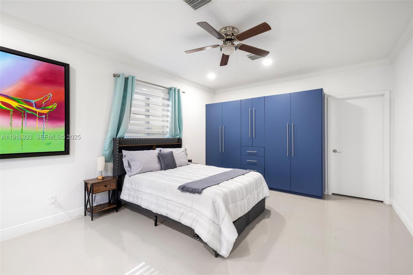 17490 Southwest 70th Place Southwest Ranches, FL 33331 - Photo 56 of 64 a bedroom with a bed and a painting on the wall