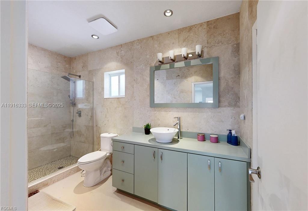 17490 Southwest 70th Place Southwest Ranches, FL 33331 - Photo 57 of 64 a bathroom with a toilet sink and mirror