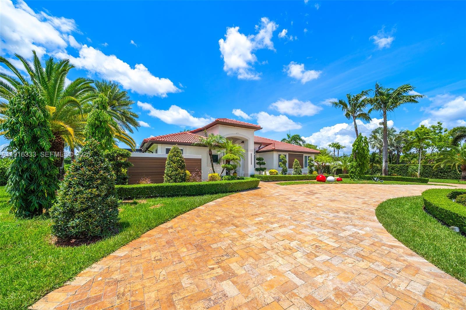 17490 Southwest 70th Place Southwest Ranches, FL 33331 - Photo 61 of 64 a front view of a house with a yard and potted plants