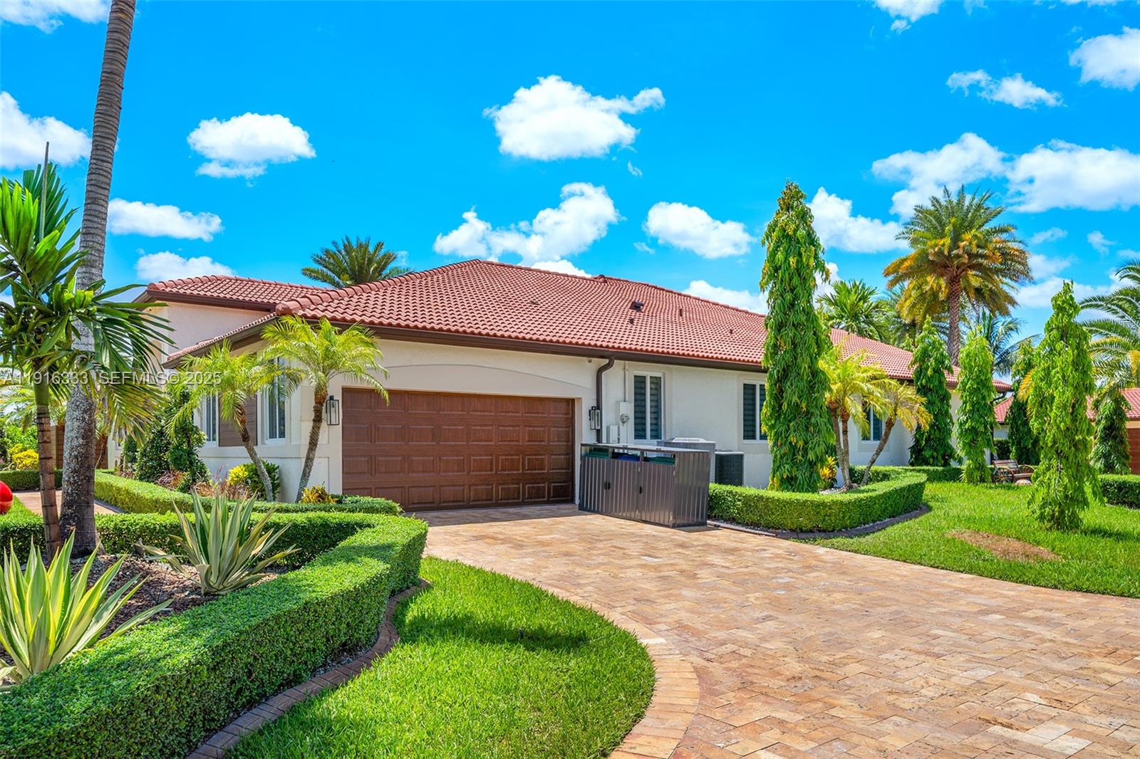 17490 Southwest 70th Place Southwest Ranches, FL 33331 - Photo 9 of 64 a front view of a house with a yard and potted plants