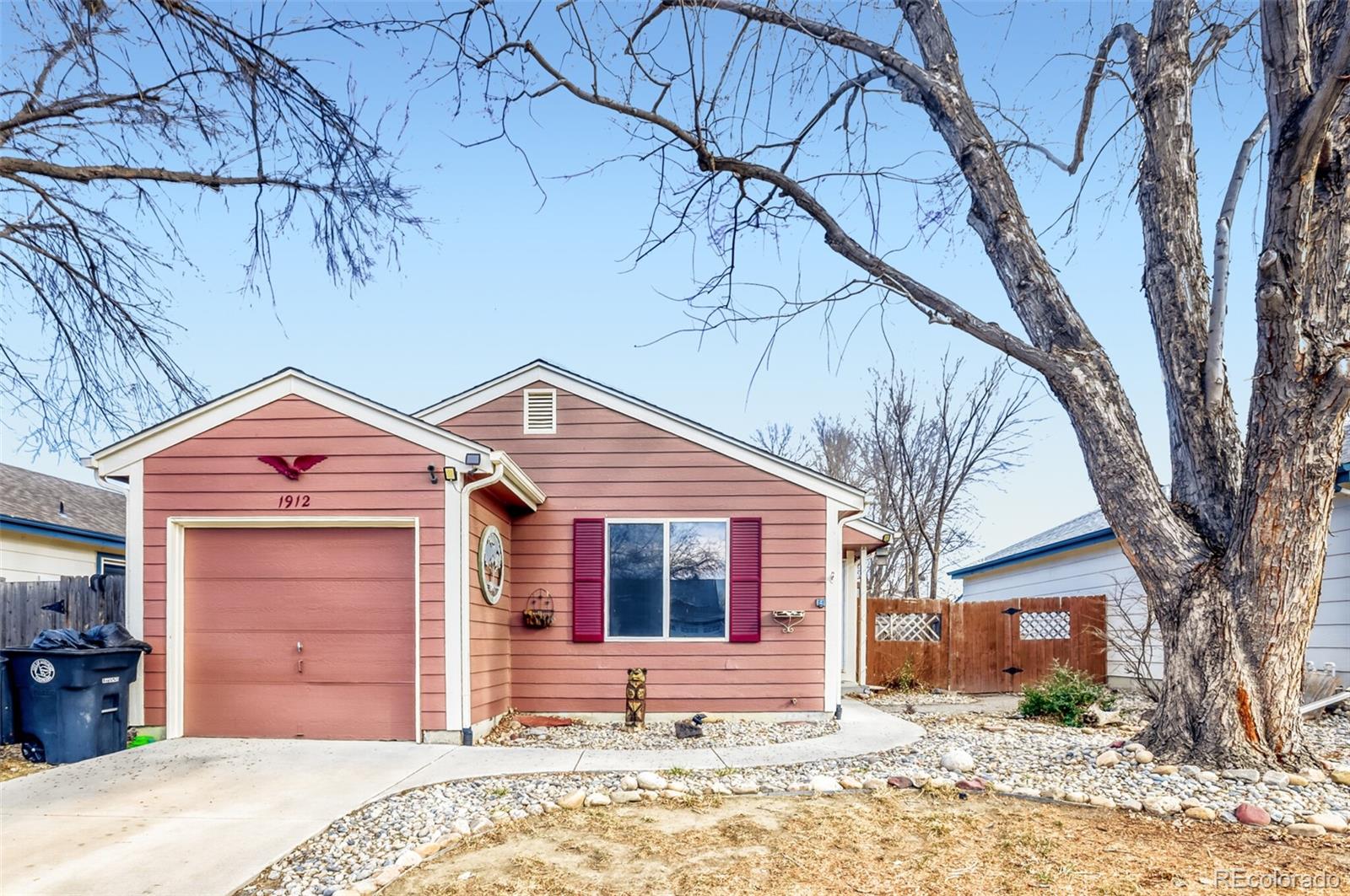 1912 Rice Street Longmont, CO 80501 - Photo 1 of 29 a front view of a house with a yard and garage