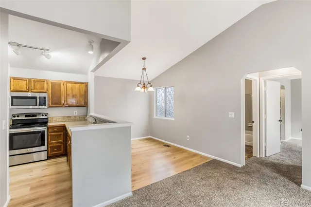 a view of a kitchen with a stove cabinets and wooden floor