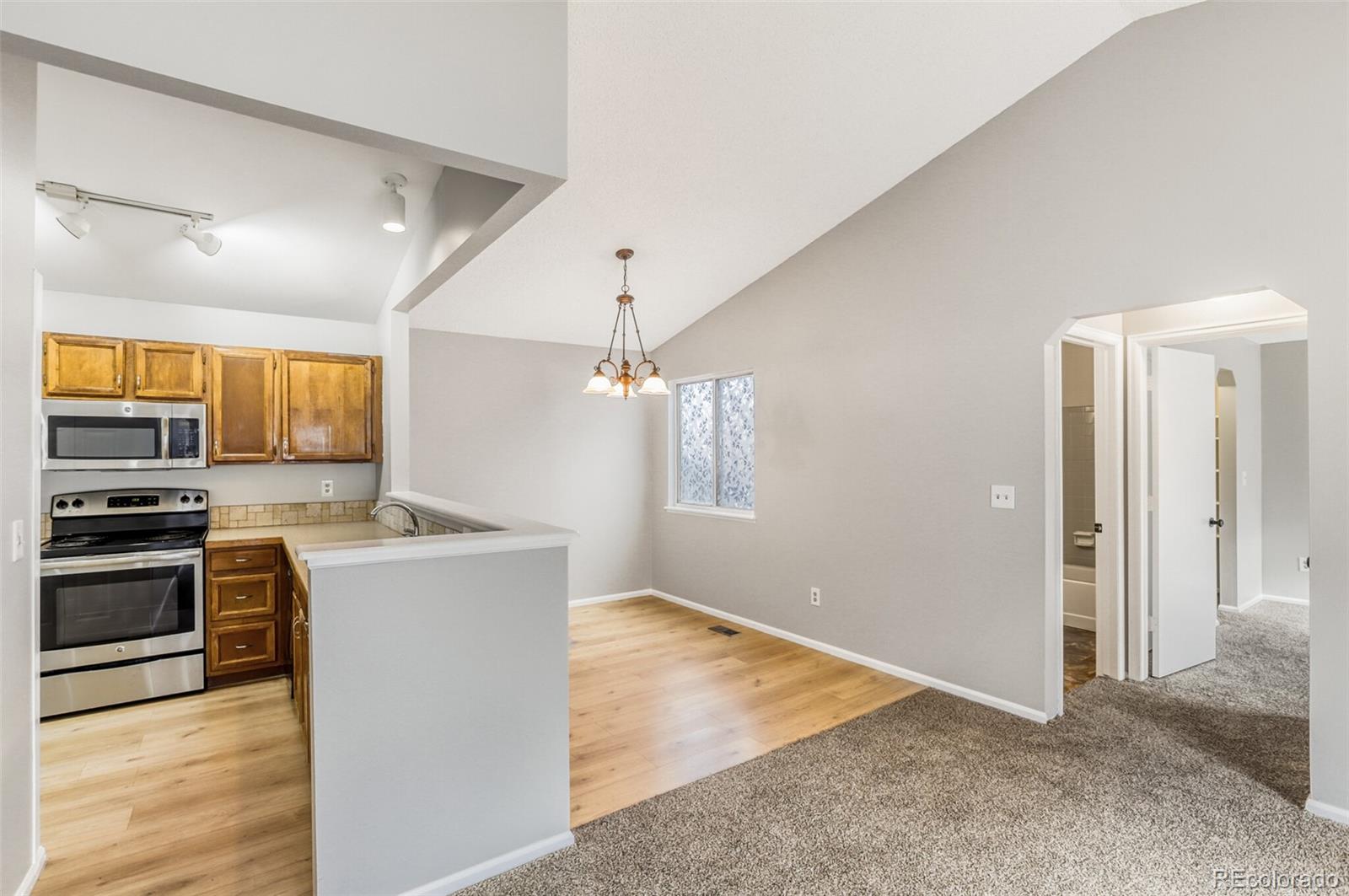 1912 Rice Street Longmont, CO 80501 - Photo 11 of 29 a view of a kitchen with a stove cabinets and wooden floor