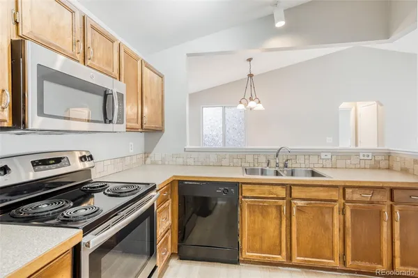 a kitchen with stainless steel appliances granite countertop a stove and a sink