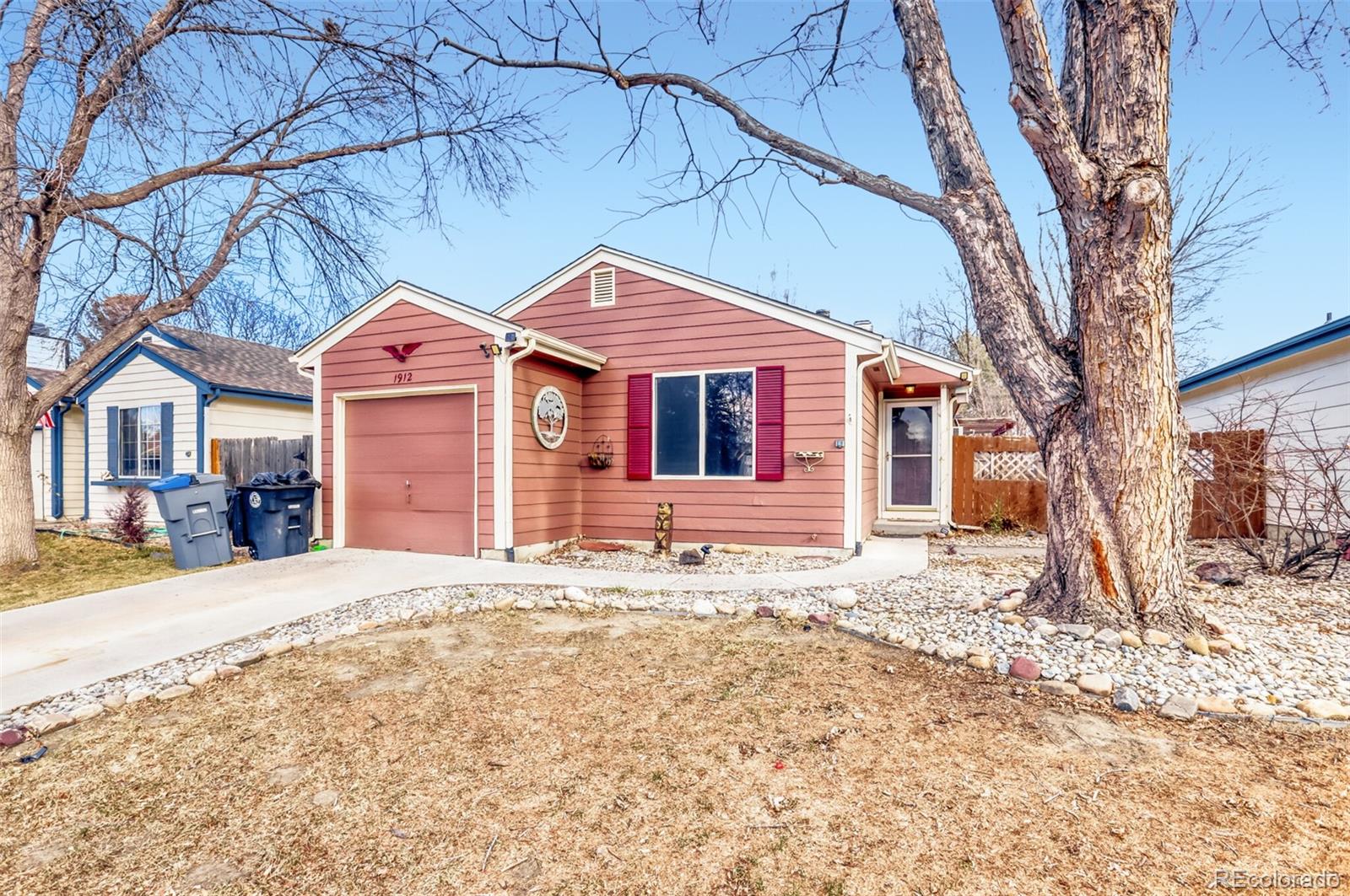 1912 Rice Street Longmont, CO 80501 - Photo 2 of 29 a front view of a house with a yard covered in snow