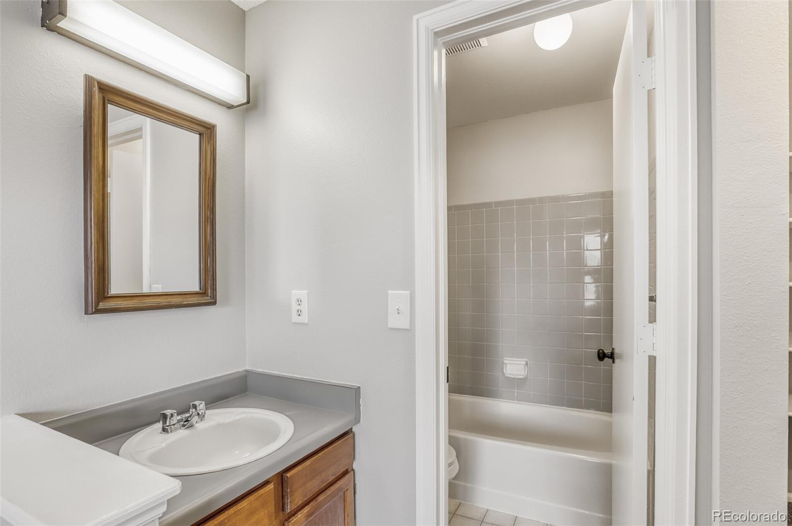 1912 Rice Street Longmont, CO 80501 - Photo 21 of 29 a bathroom with a sink and a mirror