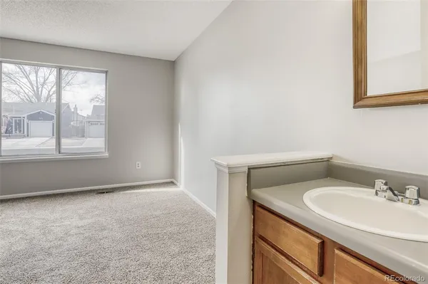 a bathroom with a sink a vanity and a window