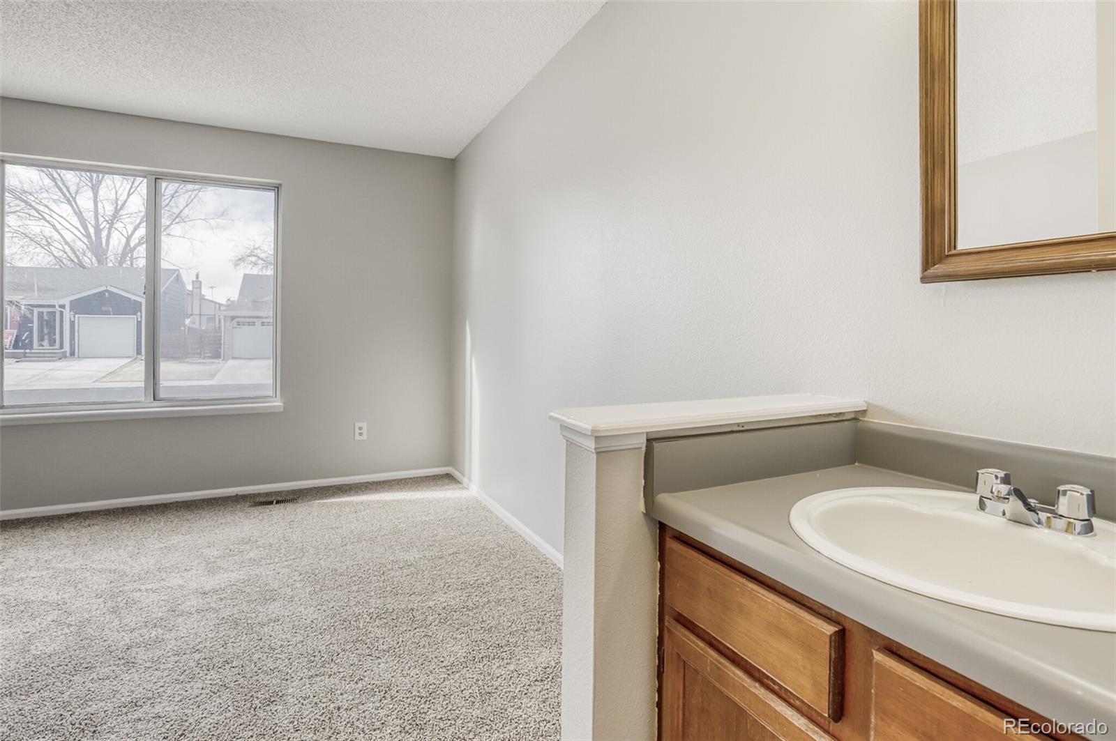 1912 Rice Street Longmont, CO 80501 - Photo 23 of 29 a bathroom with a sink a vanity and a window
