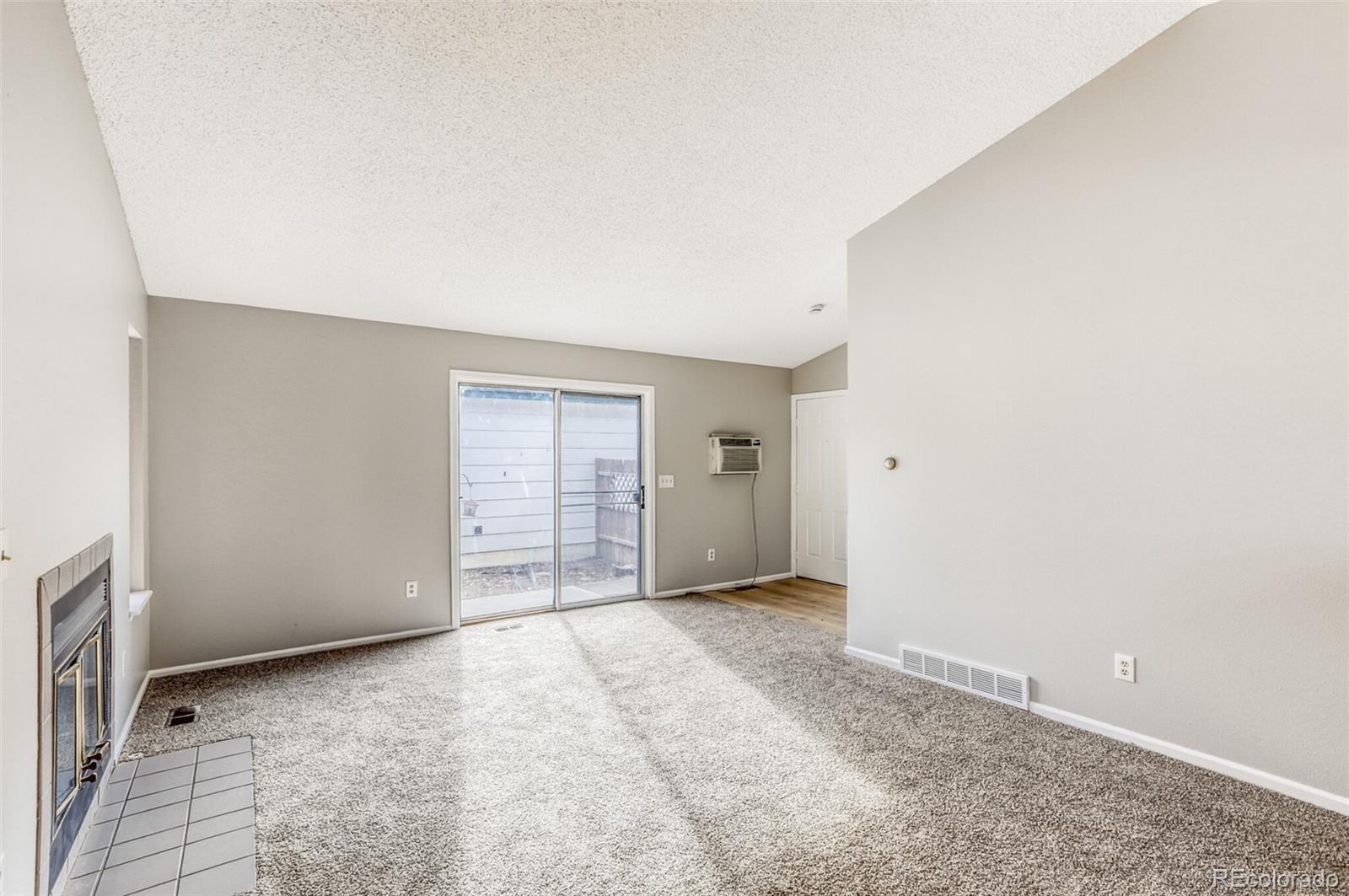 1912 Rice Street Longmont, CO 80501 - Photo 5 of 29 an empty room with windows