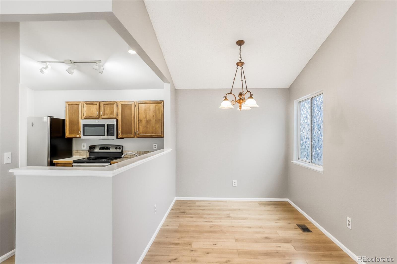 1912 Rice Street Longmont, CO 80501 - Photo 9 of 29 a view of a kitchen with a sink wooden floor and a living room