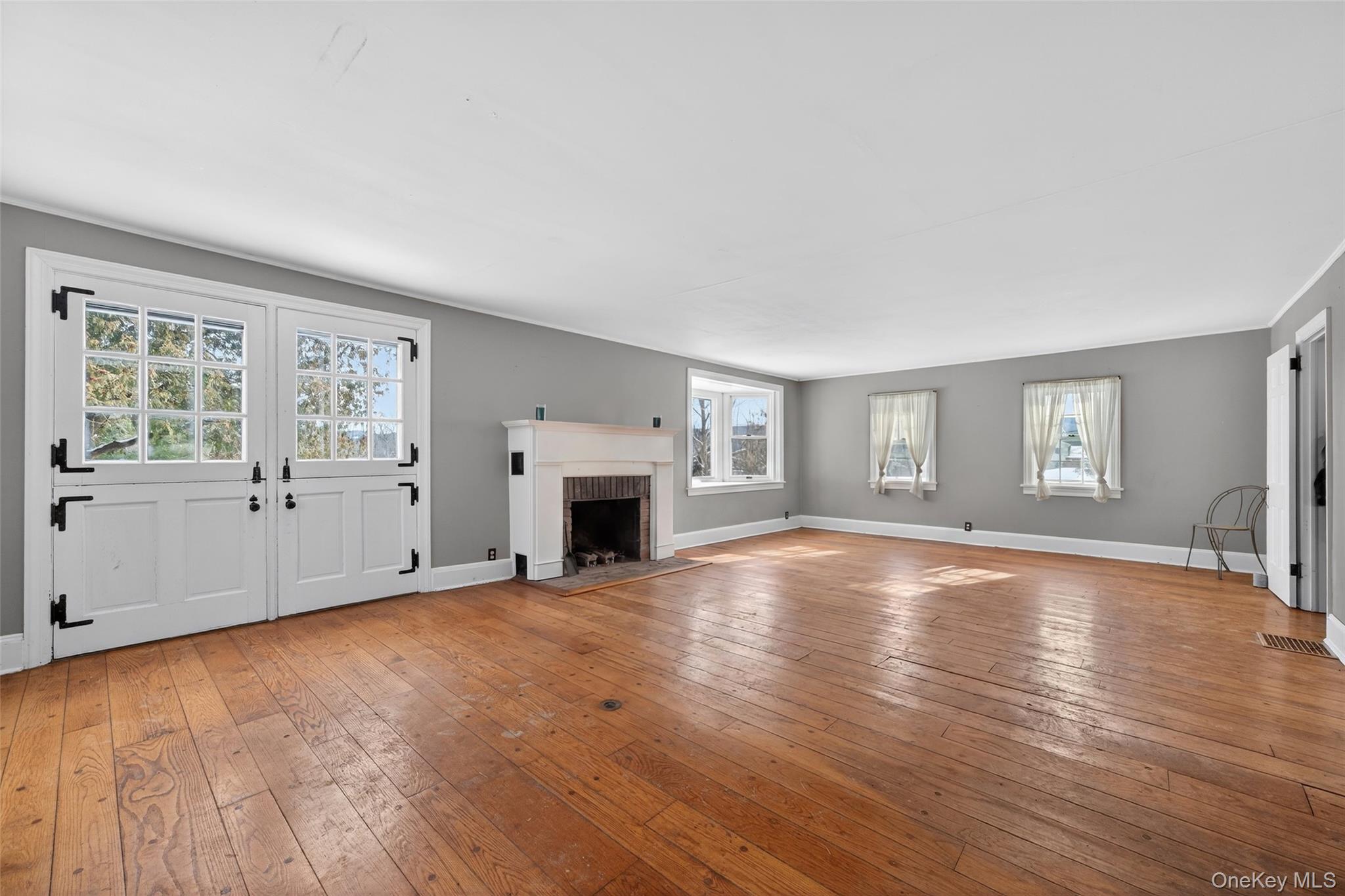 74 Onderdonk Road Warwick, NY 10990 - Photo 13 of 38 a view of an empty room with window and wooden floor