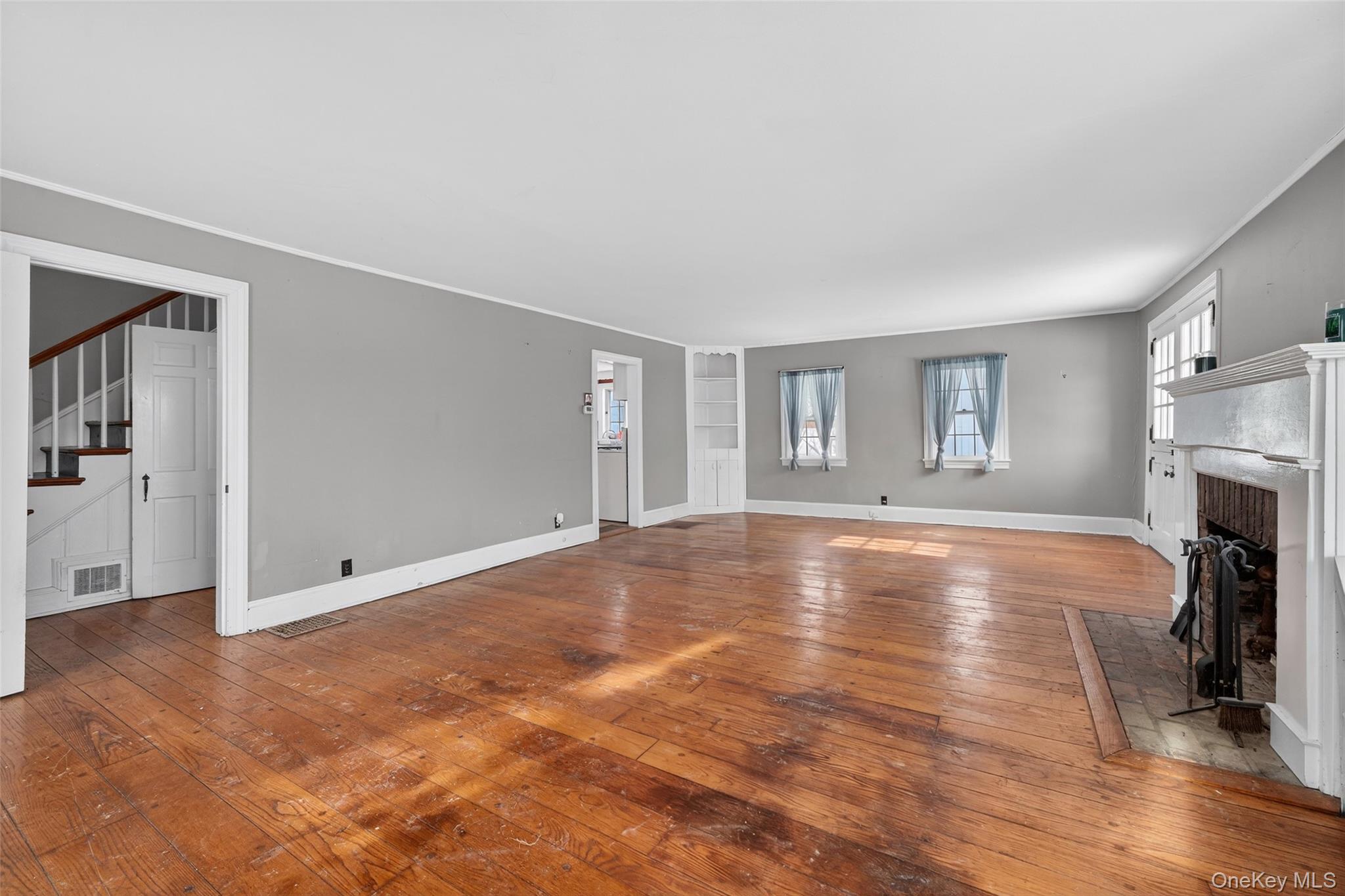 74 Onderdonk Road Warwick, NY 10990 - Photo 16 of 38 a view of empty room with fireplace and wooden floor
