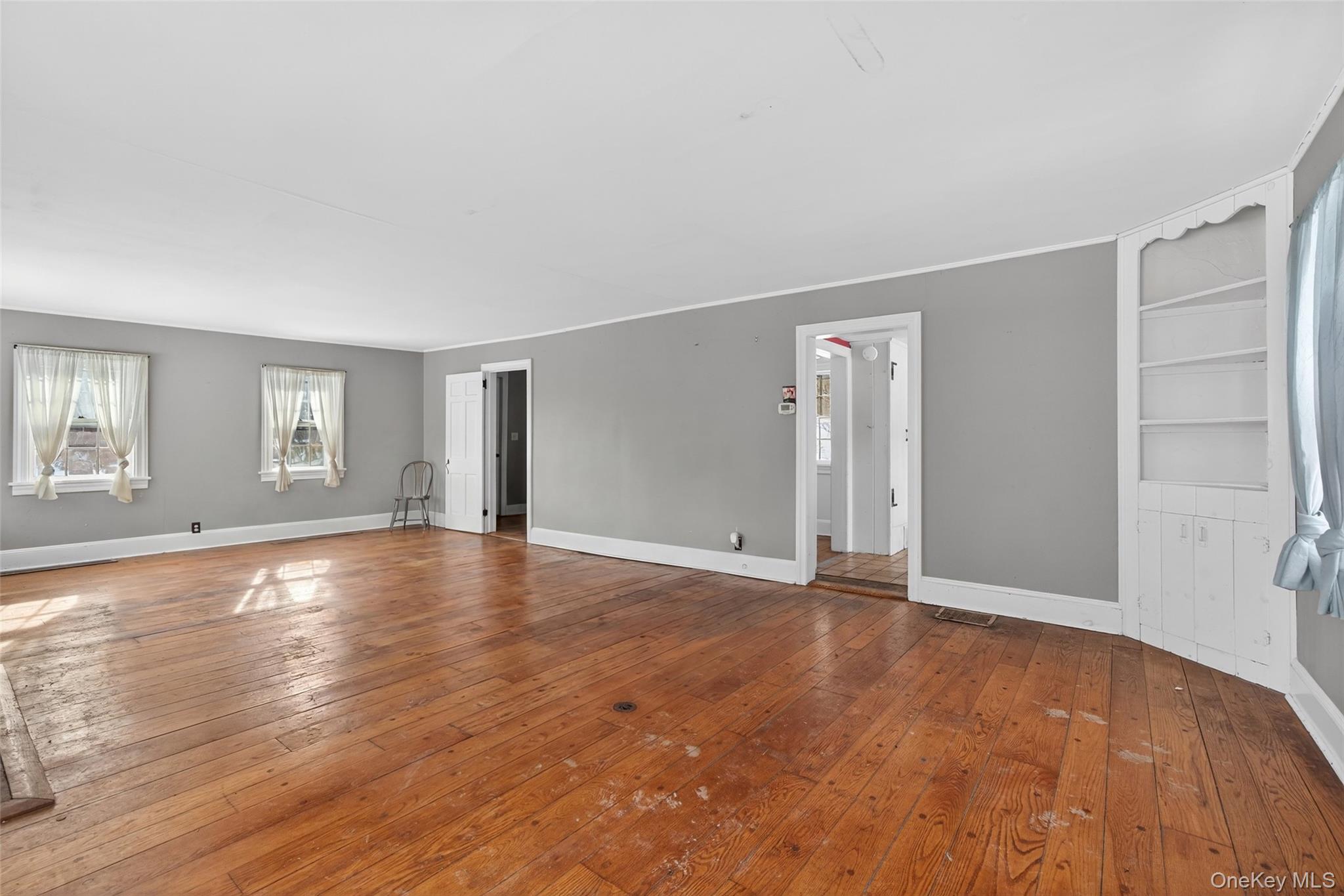 74 Onderdonk Road Warwick, NY 10990 - Photo 8 of 38 an empty room with wooden floor and windows