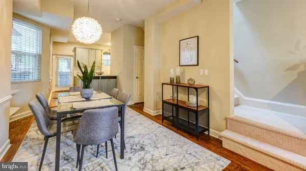 a view of a dining room with furniture and a chandelier