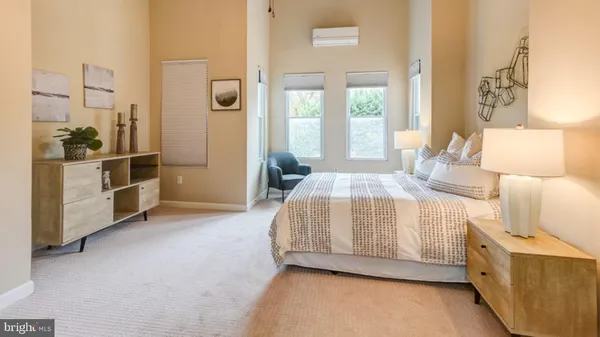 a bedroom with a bed and a large window