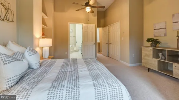 a view of a bedroom with wooden floor and windows