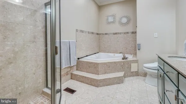 a bathroom with a tub and toilet