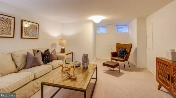 a living room with furniture and a chair