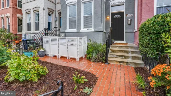 a front view of a house with a yard and outdoor seating
