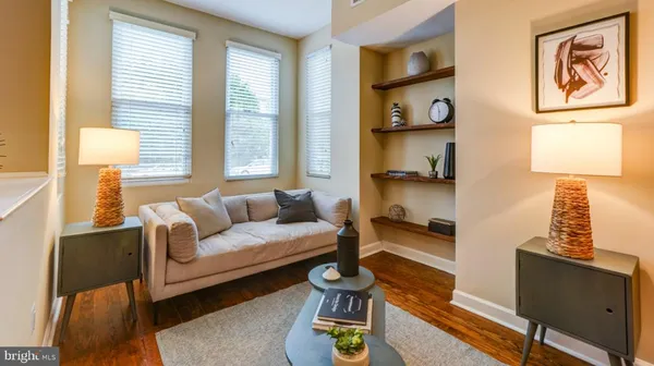 a living room with furniture a window and a lamp