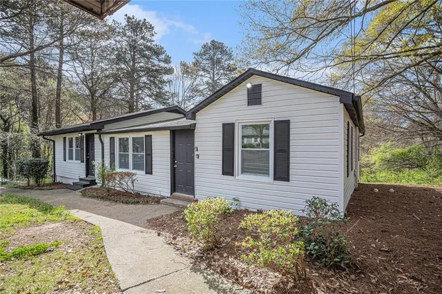 a front view of a house with a yard and outdoor seating
